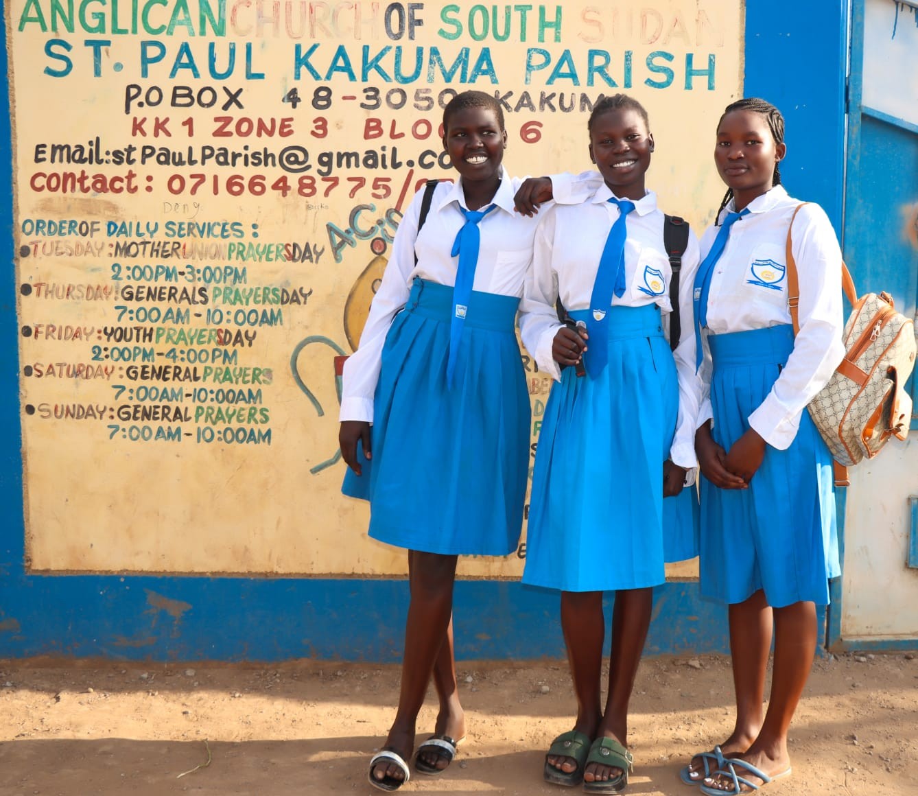 Students in school uniform outside the parish wall.